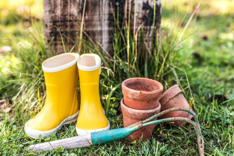 Gardening equipment, yellow wellies, pots and rake