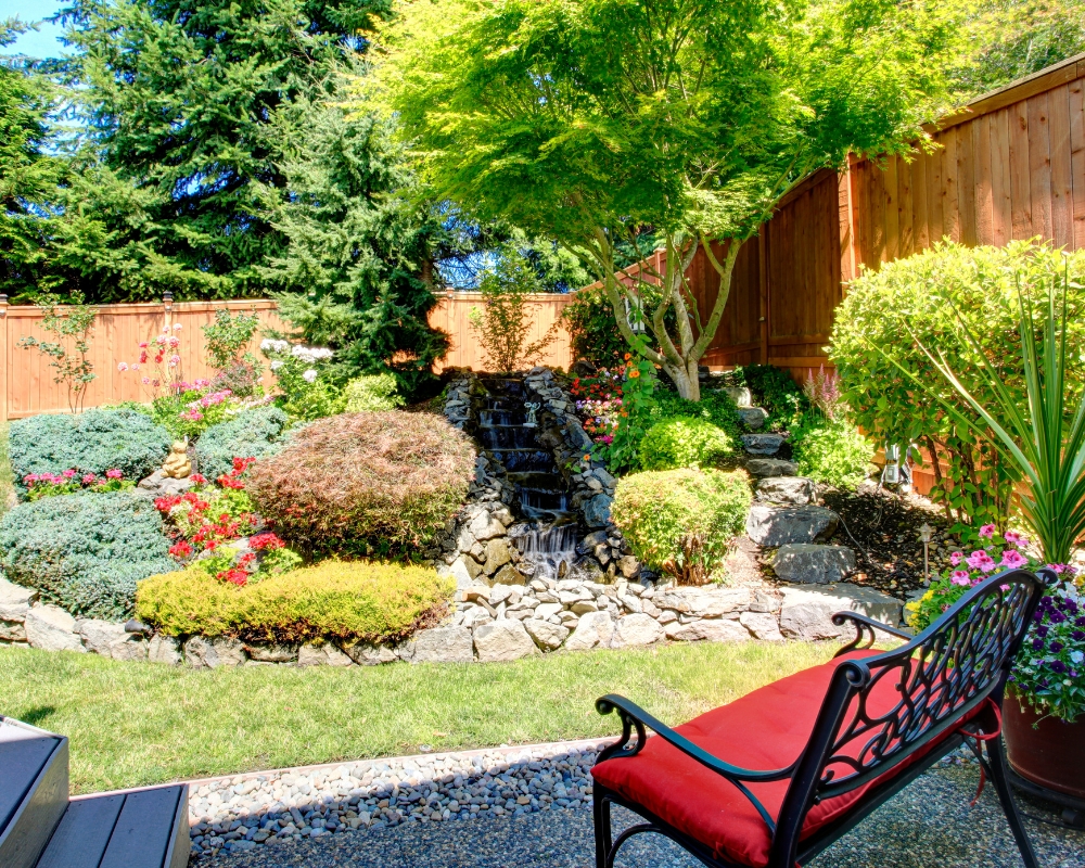 Garden with stone built waterfall and planted rockery