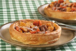 Yorkshire pudding with vegetables and beef.