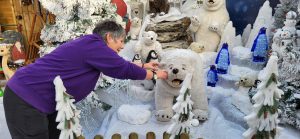 Staff member adding finishing touches to the Grotto build