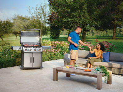 A couple in their garden enjoying a BBQ