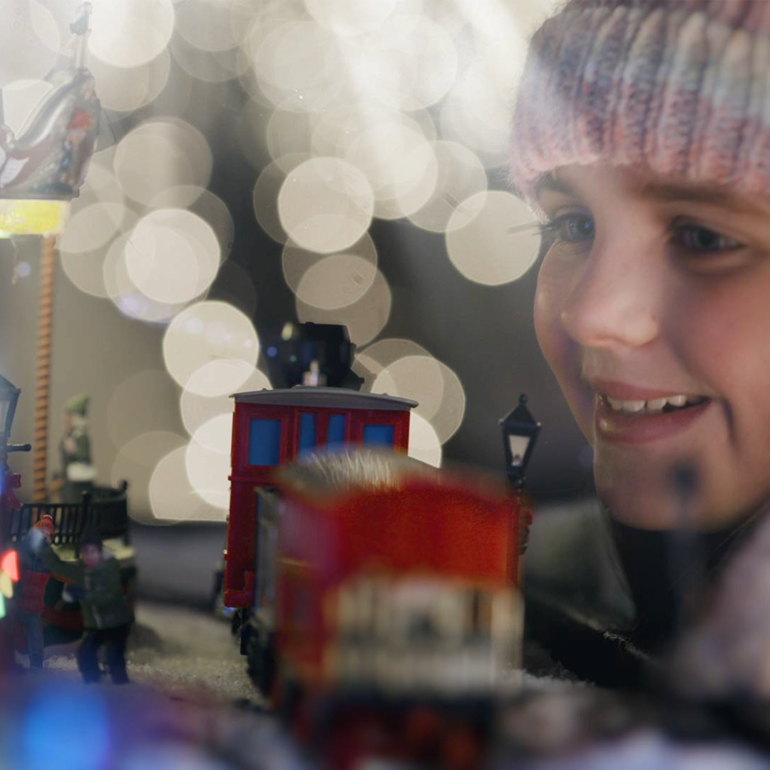Girl looking at model train
